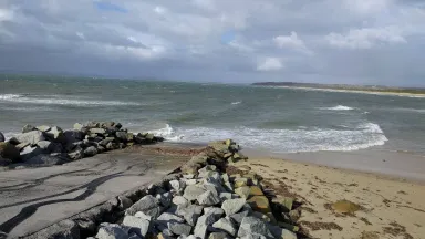 looking down a boatramp with water and sand